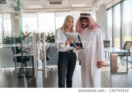 Muslim man and woman are indoors in modern building 136745832
