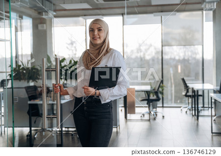 Muslim woman in hijab is in the office Muslim woman in hijab is in the office 136746129