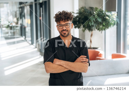 Male doctor is indoors in the modern building Male doctor is indoors in the modern building 136746214