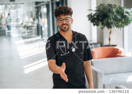 Standing and posing. Doctor is indoors in the modern building Standing and posing. Doctor is indoors in the modern building 136746218