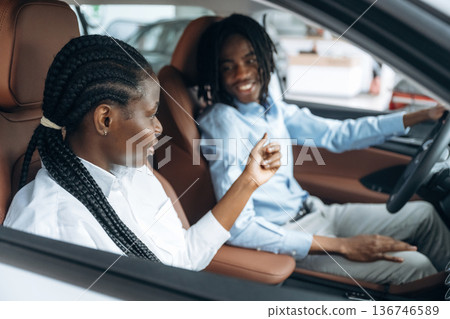 Having a ride. Man and woman are in the automobile Having a ride. Man and woman are in the automobile 136746589