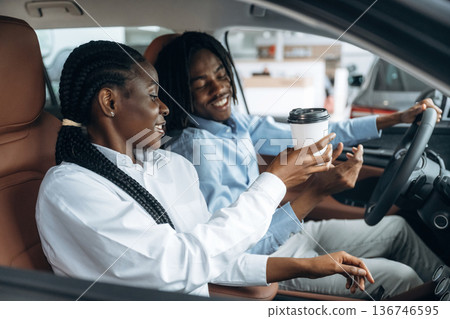 Sweet couple. Man and woman are in the automobile 136746595
