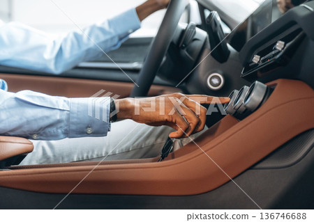 Pushing the button. Man in shirt is in the modern car Pushing the button. Man in shirt is in the modern car 136746688