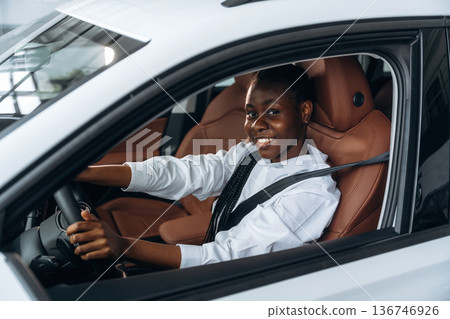In white shirt. Woman is in the modern car In white shirt. Woman is in the modern car 136746926