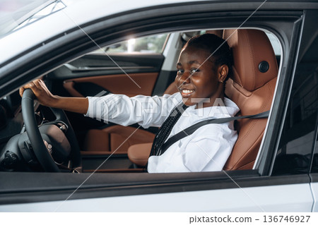 In white shirt. Woman is in the modern car In white shirt. Woman is in the modern car 136746927