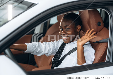 Woman in white shirt is in the modern car Woman in white shirt is in the modern car 136746928