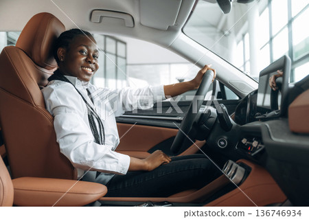 Formal white shirt, driving. Woman is in the modern car Formal white shirt, driving. Woman is in the modern car 136746934