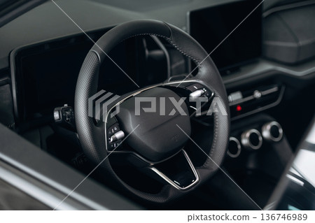 Steering wheel, front part. Detailed close up view of modern car interior Steering wheel, front part. Detailed close up view of modern car interior 136746989