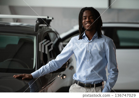 Front view. Car seller, businessman is standing in automobile salon Front view. Car seller, businessman is standing in automobile salon 136747029