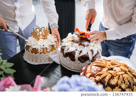 Traditional wedding bread cutting ceremony during festive marriage celebration Traditional wedding bread cutting ceremony during festive marriage celebration 136747435