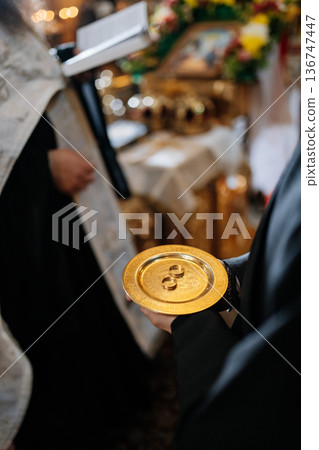 Wedding rings on golden plate during Orthodox church marriage ceremony ritual Wedding rings on golden plate during Orthodox church marriage ceremony ritual 136747447
