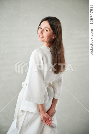 Studio portrait of beautiful happy woman in white attire before Thai massage. 136747952