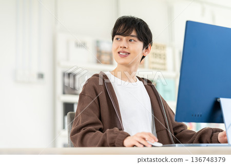 A young engineer man working in the office A young engineer man working in the office 136748379