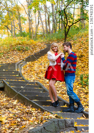Romantic pair meet in park standing on stairs. Romantic pair meet in park standing on stairs. 136748391