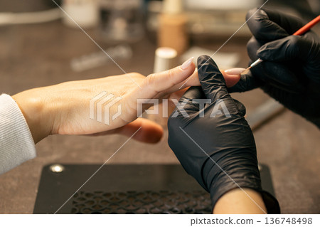 View of the process of a manicure being performed by a master View of the process of a manicure being performed by a master 136748498
