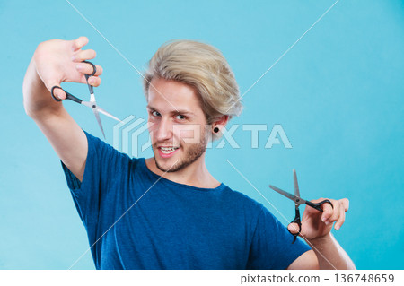 Man with scissors for haircutting Man with scissors for haircutting 136748659