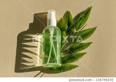 Transparent Cosmetic spray bottle and green leaf, natural light and shadow, dispenser with green liquid on beige. Natural Vegan skin care products, Eco-friendly Organic cosmetics concept, copyspace Transparent Cosmetic spray bottle and green leaf, natural light and shadow, dispenser with green liquid on beige. Natural Vegan skin care products, Eco-friendly Organic cosmetics concept, copyspace 136749250