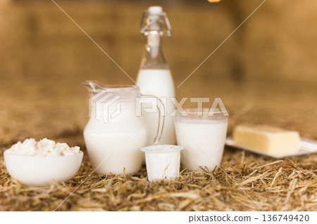 milk, cottage cheese, cream, cheese on table against the background of hay milk, cottage cheese, cream, cheese on table against the background of hay 136749420