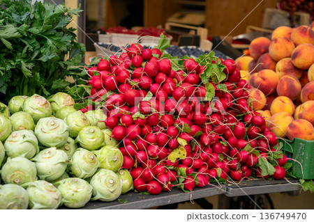 Various stacks of vegetables lie on the table for sale at the market Various stacks of vegetables lie on the table for sale at the market 136749470