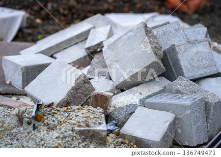 A mountain of rubble and the remains of old paving stones at a construction site 136749471