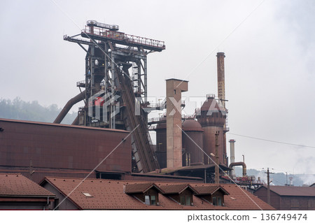 Industrial metallurgical plant in the morning fog. Industrial plant with belt conveyor 136749474