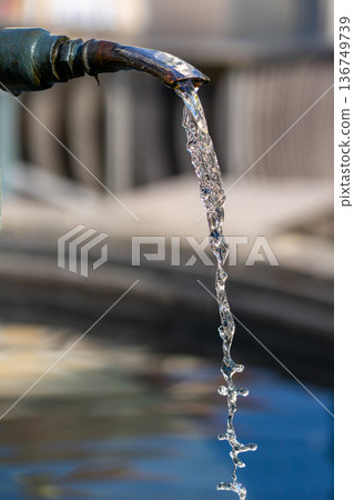 Drinking water flows from the tap of a city fountain Drinking water flows from the tap of a city fountain 136749739