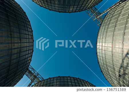 Industrial series of silver grain silos and port terminal logistics. Industrial series of silver grain silos and port terminal logistics. 136751389