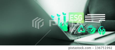 Business person using laptop with ESG icon virtual screen for Environmental Social Governance concept, sustainable development and green corporate responsibility strategy. 136751992