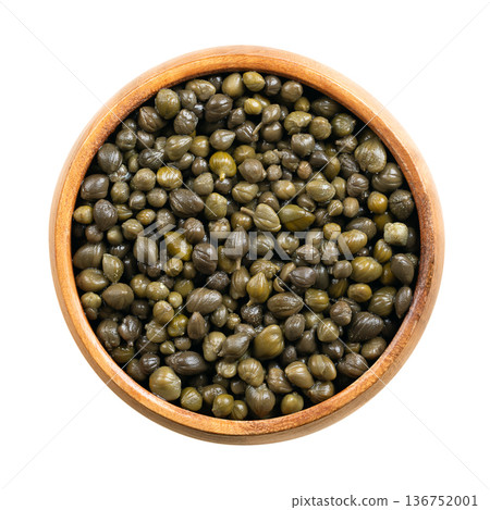 Capers non-pareilles, preserved in vinegar, in a wooden bowl. Smallest, most delicate, and highest variety of capers. Tiny buds with intense, tangy flavor, firm texture, and bright, salty pop. Photo Capers non-pareilles, preserved in vinegar, in a wooden bowl. Smallest, most delicate, and highest variety of capers. Tiny buds with intense, tangy flavor, firm texture, and bright, salty pop. Photo 136752001