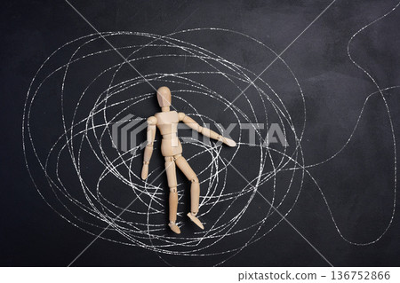 A wooden, articulated figure of a man lies in the center of a chaotic web of chalk lines. A wooden, articulated figure of a man lies in the center of a chaotic web of chalk lines. 136752866