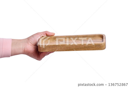 Female hand holding empty wooden tray on isolated background Female hand holding empty wooden tray on isolated background 136752867