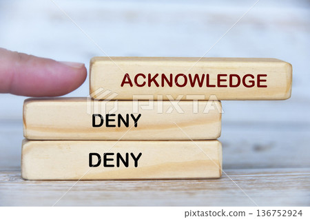 Acknowledge and Deny text on wooden blocks highlighting accountability versus avoidance in leadership culture. Acknowledge and Deny text on wooden blocks highlighting accountability versus avoidance in leadership culture. 136752924