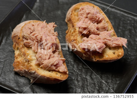 Bruschetta with canned tuna on a black plate Bruschetta with canned tuna on a black plate 136752955