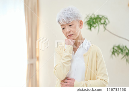 Asian senior woman worried in her room Asian senior woman worried in her room 136753568
