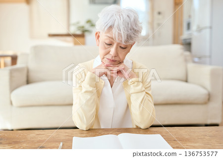 Asian senior woman resting her elbows in the living room 136753577