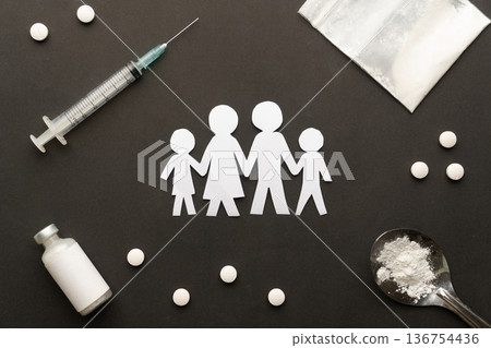 Drug addiction affects the family. Paper cut of family destroyed by drugs on dark background. International Day against Drug Abuse. Drug addiction affects the family. Paper cut of family destroyed by drugs on dark background. International Day against Drug Abuse. 136754436