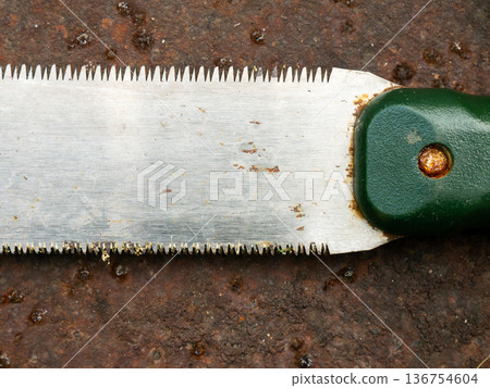 Rusty Japanese Pull Saw on Ground: Old Nokogiri Woodworking Tool Close-up Weathered Concrete Surface Detail 136754604