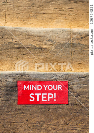 The inscription on the steps of the stairs reads Watch your step 136754831
