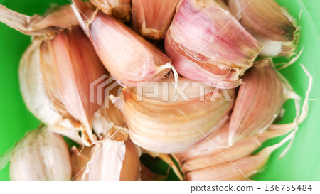 Garlic on green background. Garlic on green background. 136755484