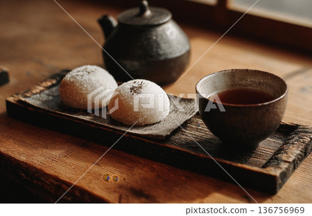Minimalist Japanese tea and traditional sweet on dark background 136756969