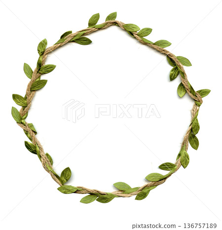 Floral frame for congratulatory text made of jute with green leaves. Round shape Floral frame for congratulatory text made of jute with green leaves. Round shape 136757189