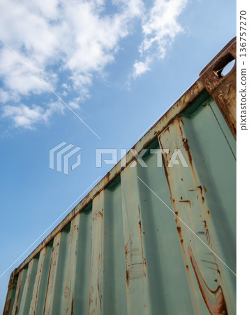 Old Rusted Shipping Container Against Blue Sky. Old Rusted Shipping Container Against Blue Sky. 136757270