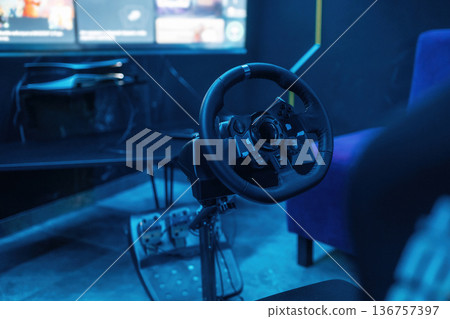 Close up view of driving simulator steering wheel and pedals Close up view of driving simulator steering wheel and pedals 136757397
