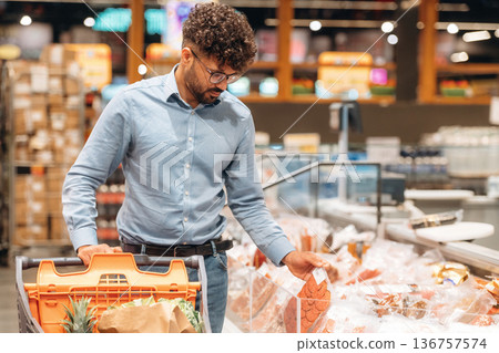 Front view. Man is in the grocery store 136757574