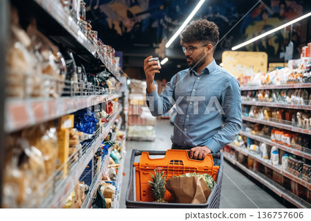 Searching for meal. Man is in the grocery store Searching for meal. Man is in the grocery store 136757606
