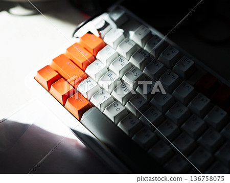Vivid composition showcasing tactile keys and moody workspace ambiance with warm contrast Vivid composition showcasing tactile keys and moody workspace ambiance with warm contrast 136758075