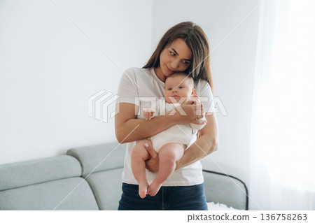 In domestic room, standing. Woman is with her little toddler baby daughter 136758263