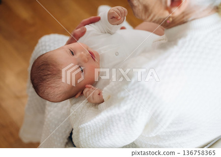 Wellness, holding kid. Grandmother with cute toddler baby at home 136758365