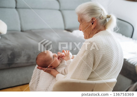 Wellness, holding kid. Grandmother with cute toddler baby at home Wellness, holding kid. Grandmother with cute toddler baby at home 136758369