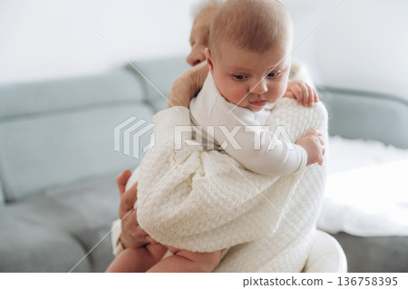 Grandmother with cute toddler baby at home Grandmother with cute toddler baby at home 136758395